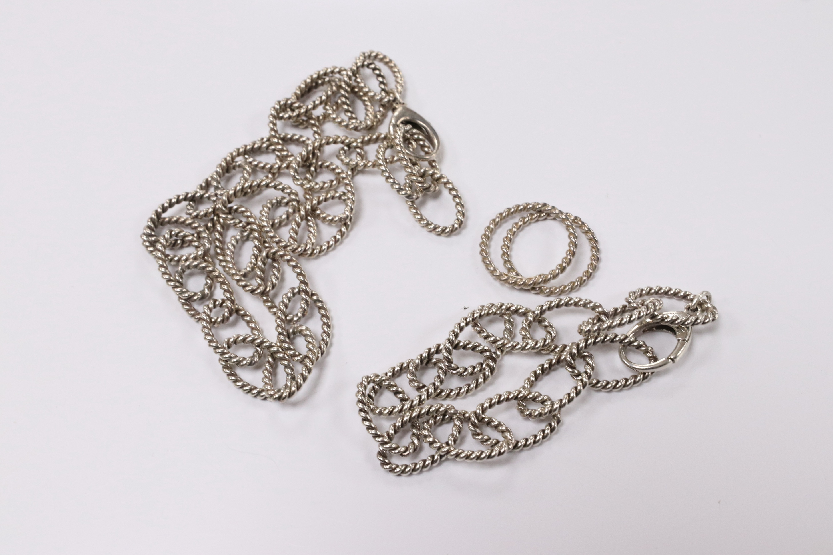 A modern Italian Tiffany & Co 925 suite of jewellery, of rope twist design, comprising a necklace, 42cm, bracelet, 18cm and two rings, size O/P and O. Condition - fair to good